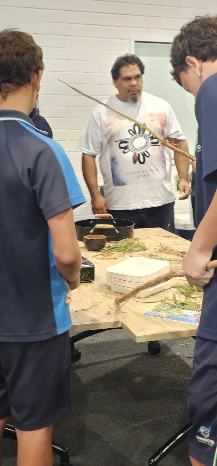 Facilitator helping participants prepare bush medicine remedies